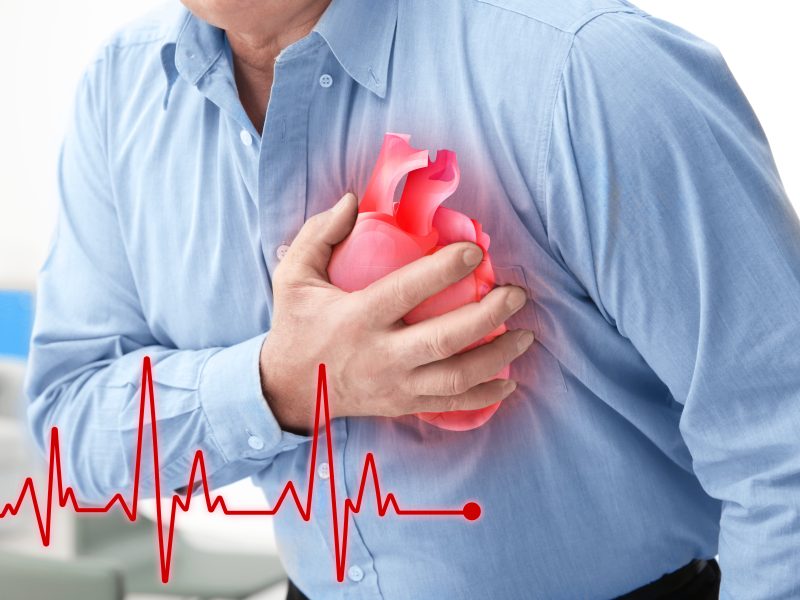 Man with chest pain suffering from heart attack in office